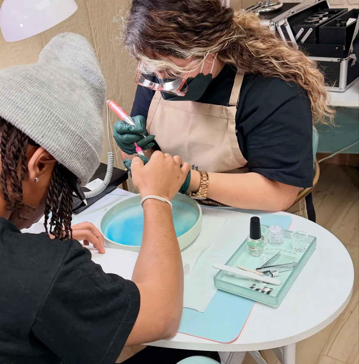 Belle Academy nail technician hands-on manicure training closeup