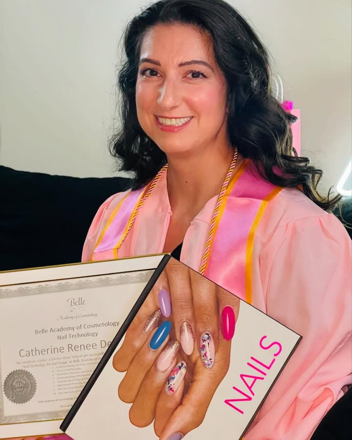 Nail technician graduate displaying manicure work