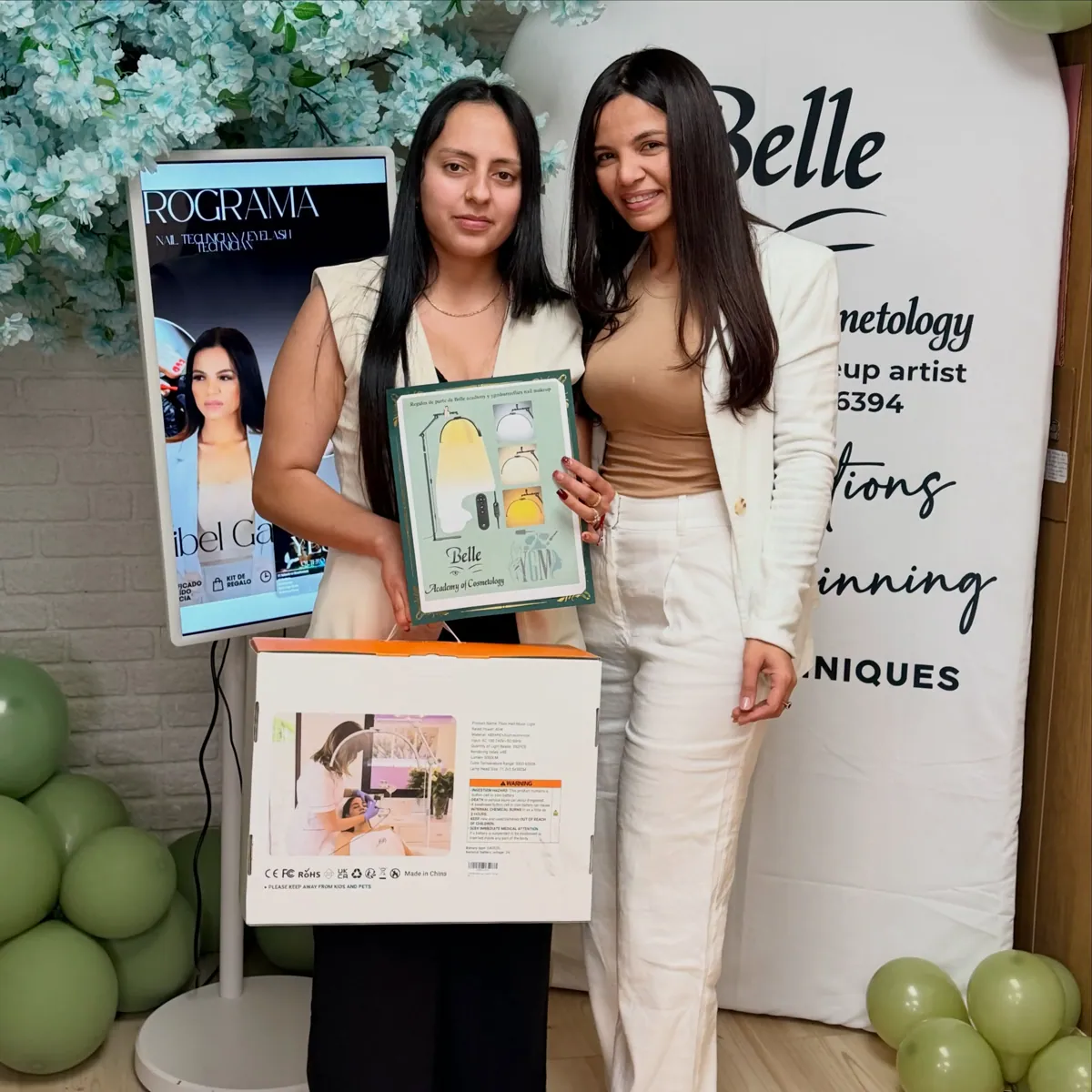Belle Academy student with model and certificate poster